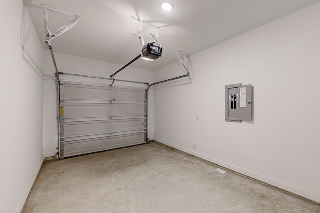 garage with a garage door opener and electric panel