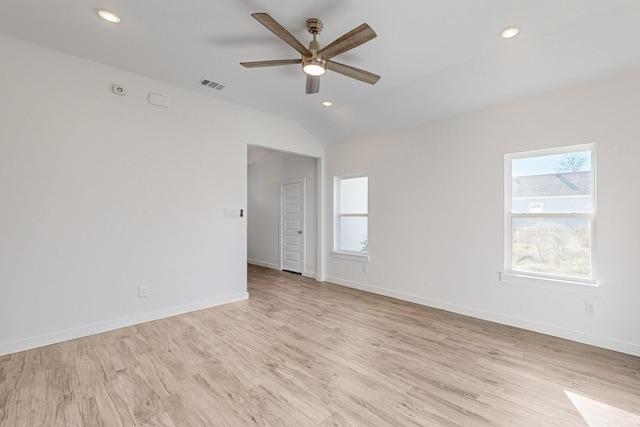 spare room featuring ceiling fan, light hardwood / wood-style floors, and vaulted ceiling