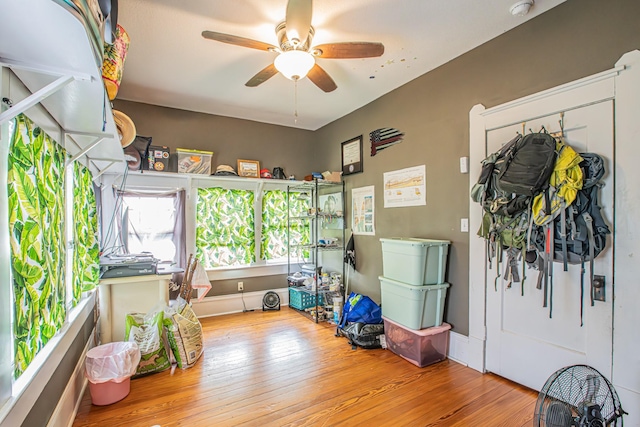 misc room with light hardwood / wood-style flooring and ceiling fan