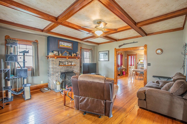 living room with a wealth of natural light, beamed ceiling, and coffered ceiling