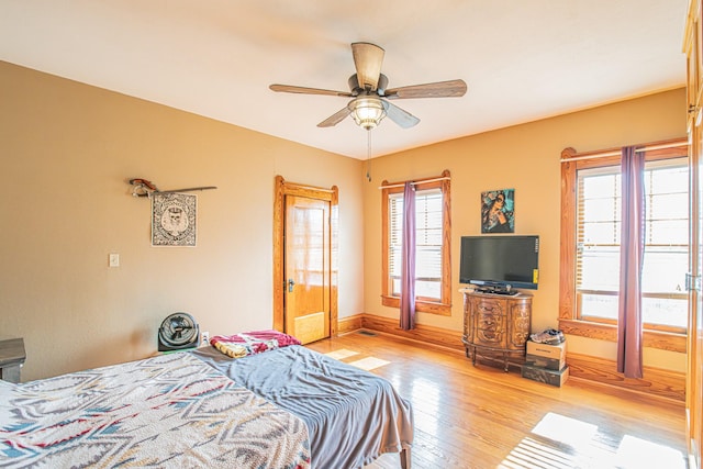 bedroom with ceiling fan and light hardwood / wood-style floors