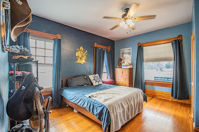 bedroom with ceiling fan and wood-type flooring