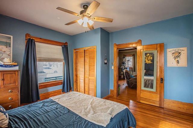 bedroom with ceiling fan, hardwood / wood-style floors, and a closet