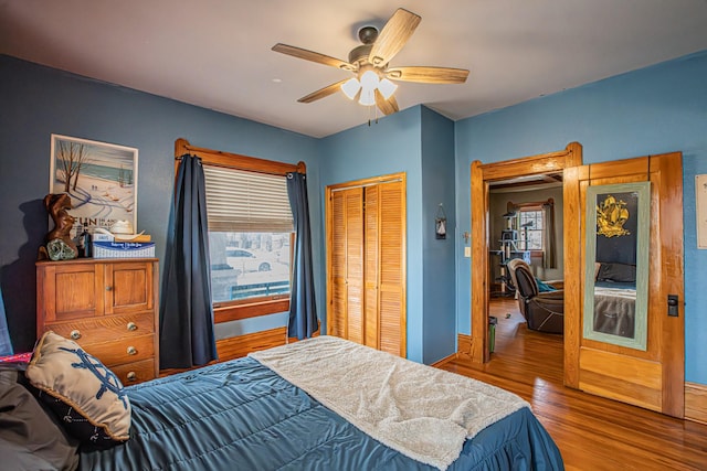 bedroom featuring ceiling fan, hardwood / wood-style floors, and a closet