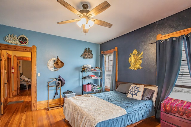 bedroom featuring ceiling fan and wood-type flooring