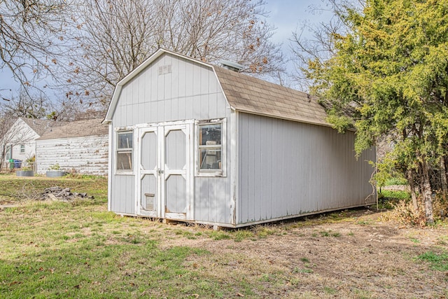 view of outbuilding with a yard