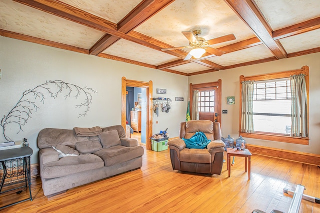 living room featuring coffered ceiling, beam ceiling, light hardwood / wood-style floors, and ceiling fan