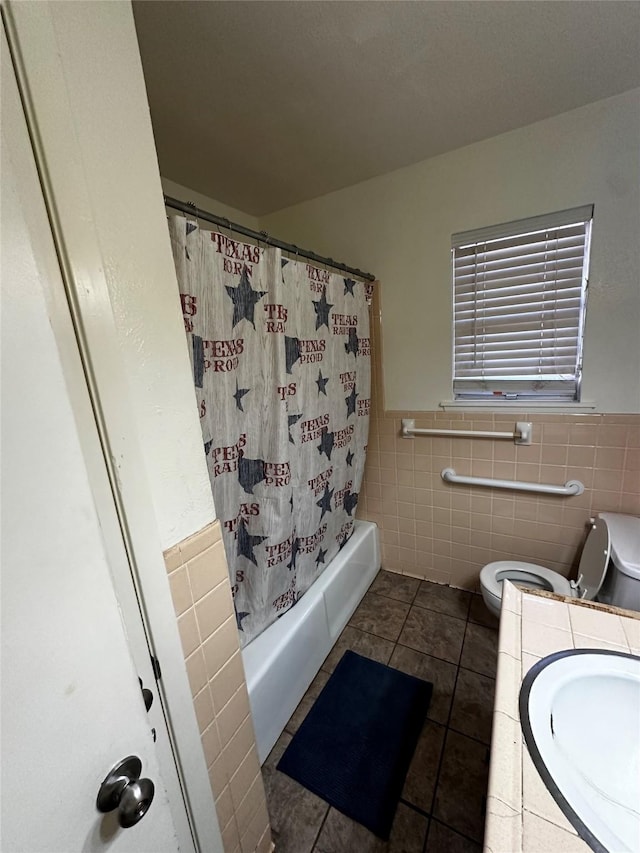 full bathroom featuring shower / bath combo, tile walls, vanity, tile patterned floors, and toilet