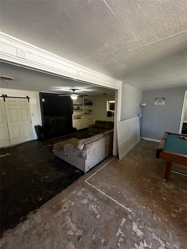 unfurnished living room with pool table and a textured ceiling