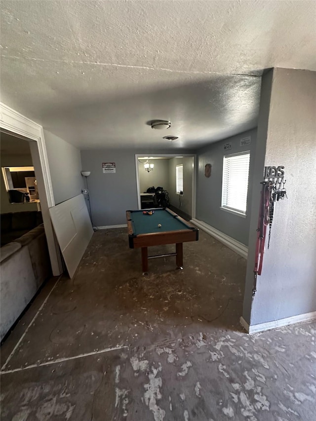 recreation room with pool table and a textured ceiling