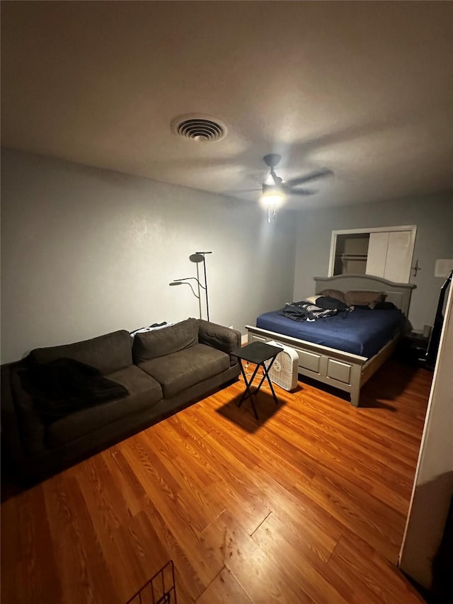 bedroom featuring hardwood / wood-style flooring and ceiling fan