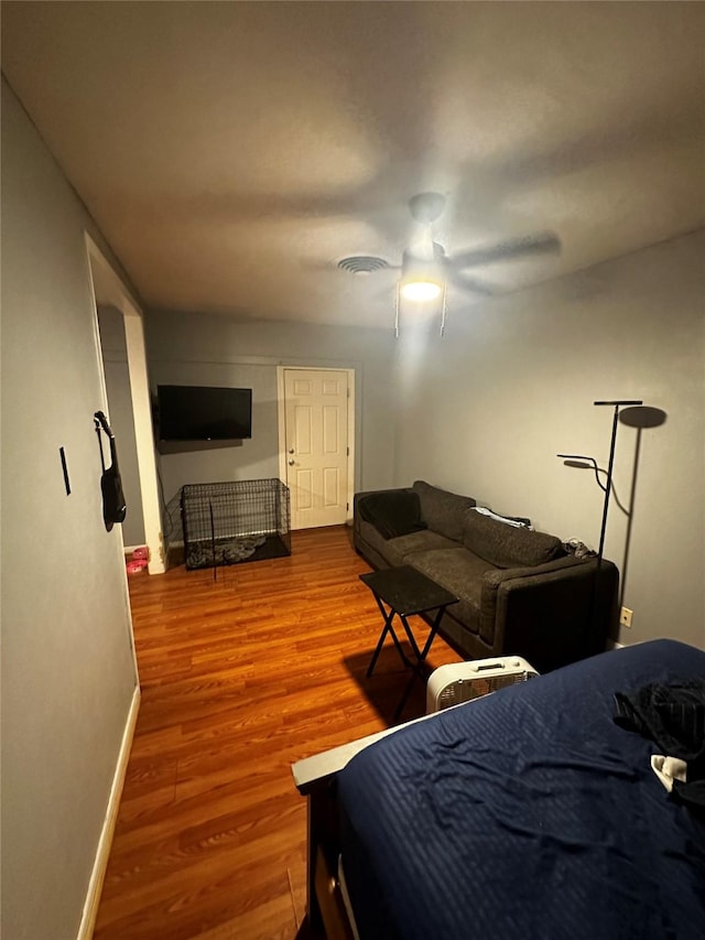 bedroom featuring wood-type flooring and ceiling fan