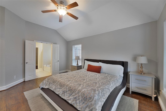 bedroom with ensuite bath, ceiling fan, dark wood-type flooring, and lofted ceiling