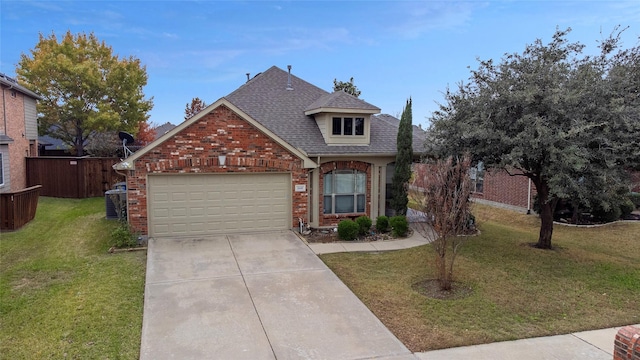 view of front of home with a front yard and a garage