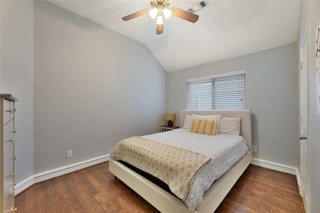 bedroom with ceiling fan, lofted ceiling, and dark wood-type flooring