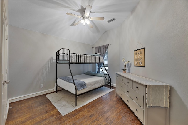 bedroom with ceiling fan, dark hardwood / wood-style floors, and lofted ceiling