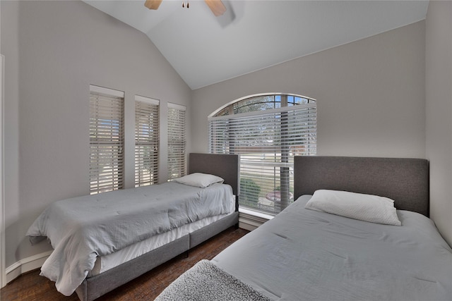 bedroom featuring ceiling fan, dark wood-type flooring, and lofted ceiling