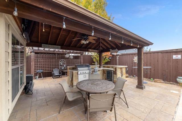 view of patio / terrace with ceiling fan, wine cooler, grilling area, a gazebo, and area for grilling