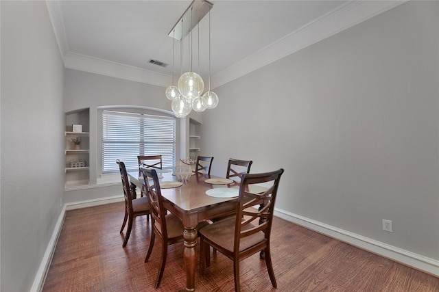 dining space featuring built in shelves, dark hardwood / wood-style flooring, and crown molding