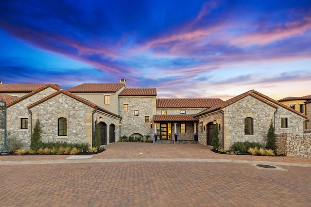 mediterranean / spanish-style house with a garage