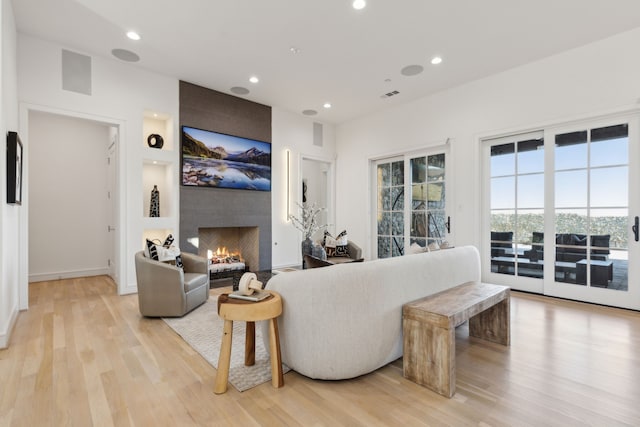 living room with a fireplace and light hardwood / wood-style floors