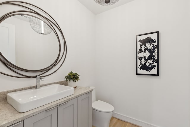 bathroom featuring hardwood / wood-style floors, vanity, and toilet