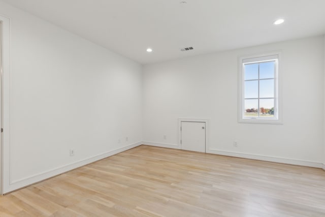 spare room with light hardwood / wood-style floors