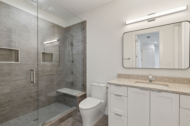 bathroom with vanity, toilet, and walk in shower