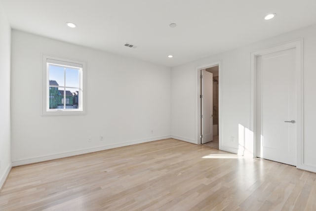 spare room featuring light hardwood / wood-style floors