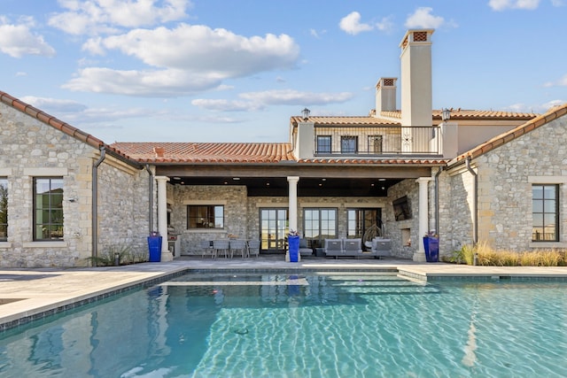 view of pool with outdoor lounge area and a patio