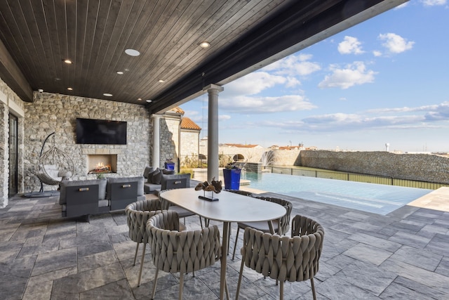 view of patio featuring an outdoor stone fireplace