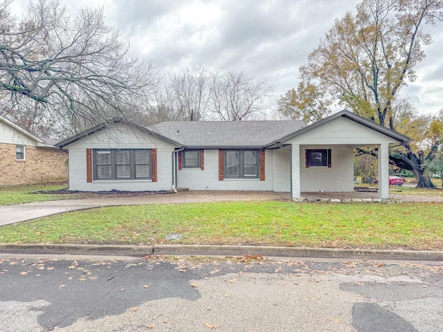 view of front of house with a carport and a front lawn