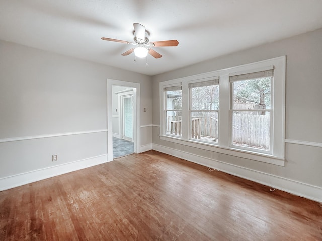 empty room with ceiling fan and hardwood / wood-style flooring