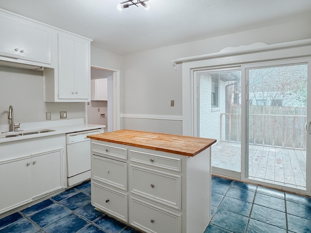 kitchen with wood counters, a center island, dishwasher, sink, and white cabinetry