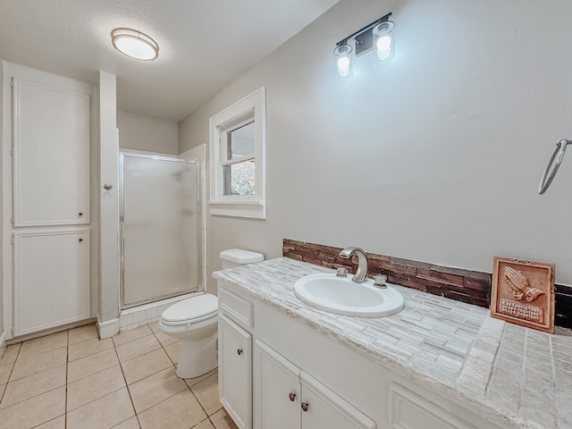 bathroom with vanity, tile patterned floors, toilet, a textured ceiling, and a shower with shower door