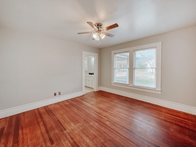 spare room featuring hardwood / wood-style floors, a textured ceiling, and ceiling fan