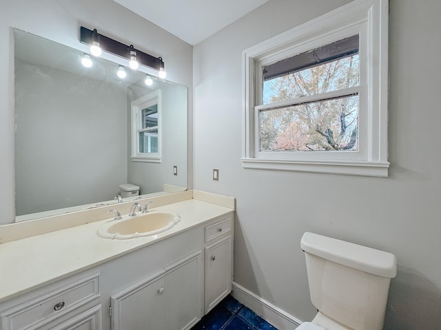 bathroom featuring vanity and toilet