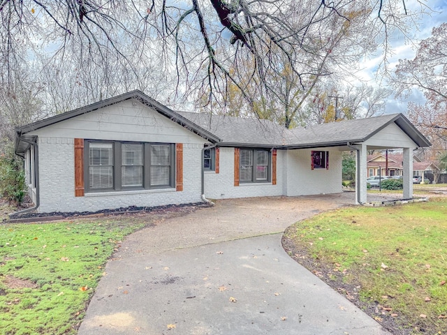 ranch-style home featuring a front yard and a carport