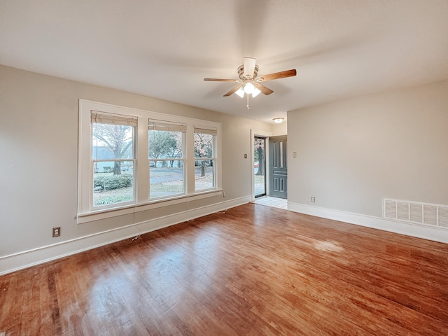 spare room with hardwood / wood-style flooring and ceiling fan