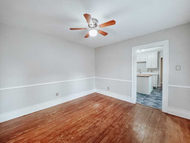 spare room with wood-type flooring and ceiling fan