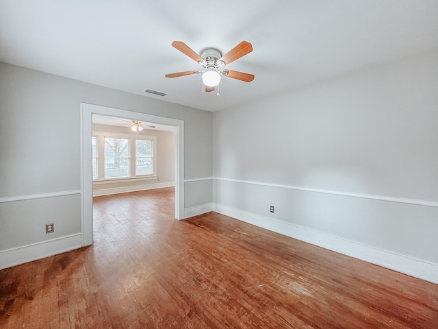 unfurnished room with hardwood / wood-style floors and ceiling fan