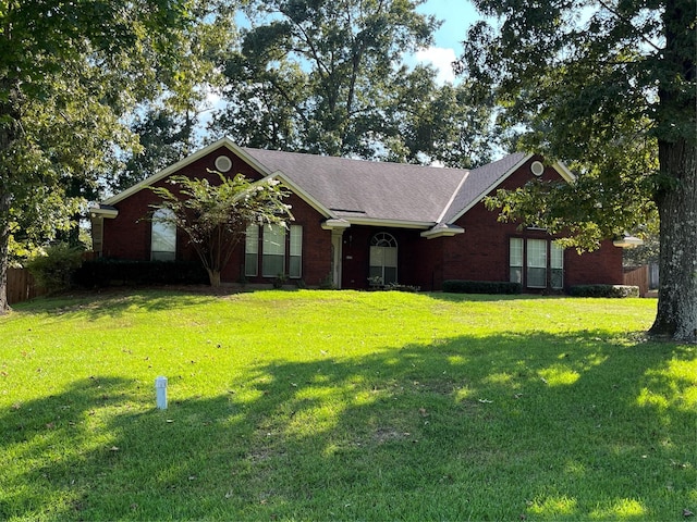 single story home featuring brick siding and a front yard