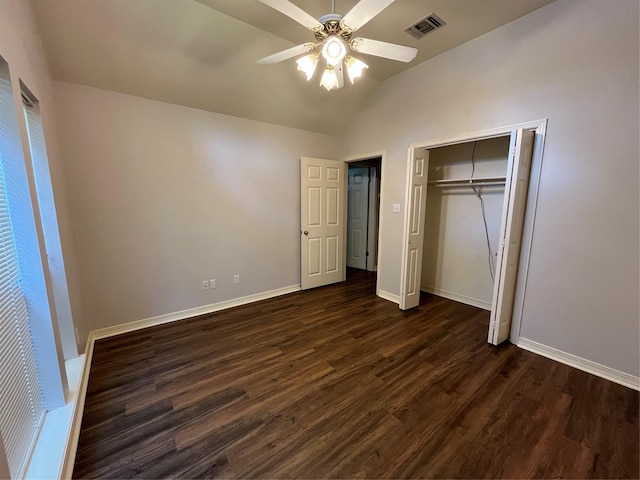 unfurnished bedroom with a closet, ceiling fan, lofted ceiling, and dark hardwood / wood-style floors