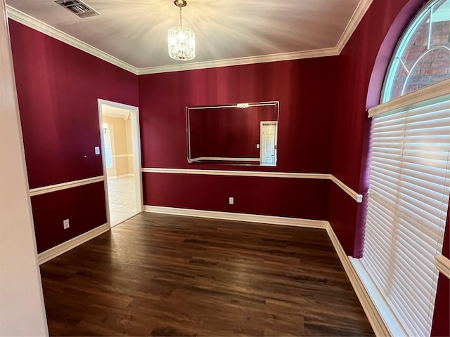 unfurnished room featuring crown molding, visible vents, baseboards, dark wood finished floors, and an inviting chandelier