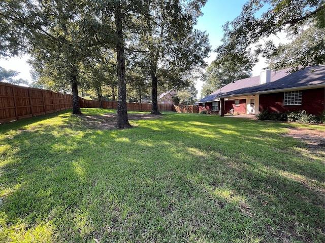 view of yard with a fenced backyard