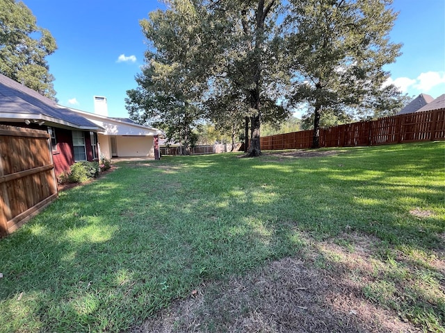 view of yard with a fenced backyard