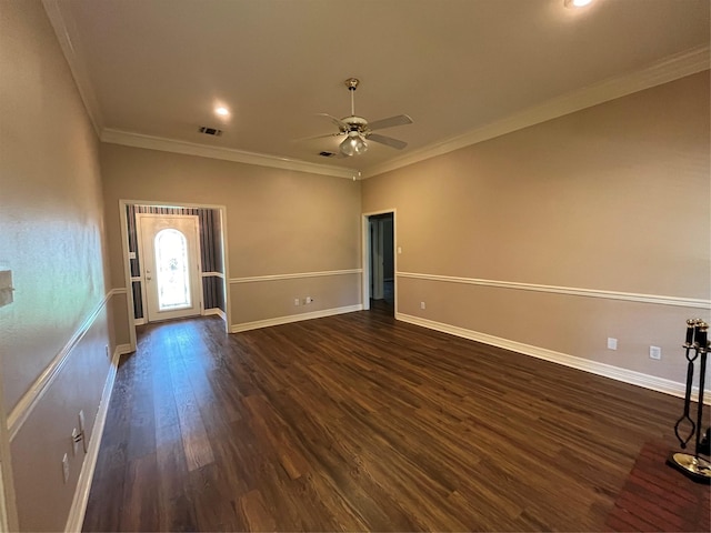 empty room with ceiling fan, ornamental molding, and dark wood-type flooring