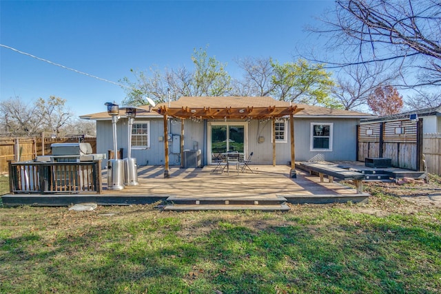 back of property featuring a lawn, a deck, a pergola, and central AC