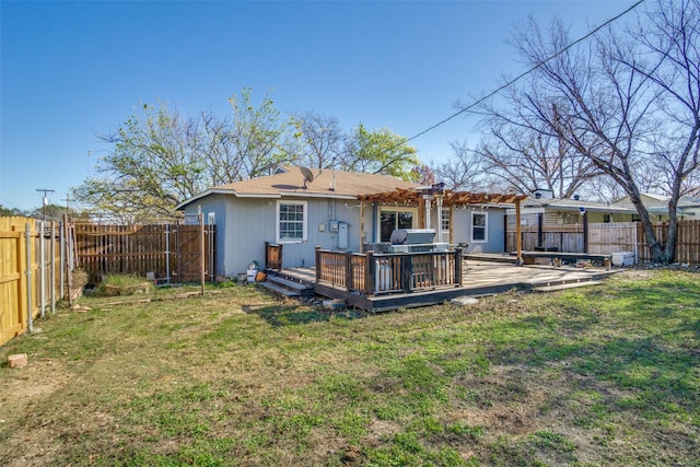 rear view of house with a pergola, a yard, and a deck