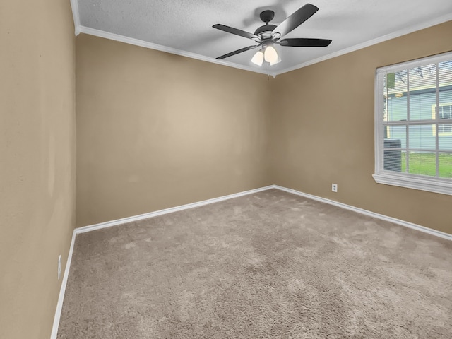 carpeted empty room featuring ceiling fan, a textured ceiling, and ornamental molding